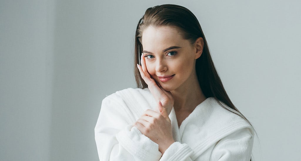 beautiful young girl in a bathrobe smiling